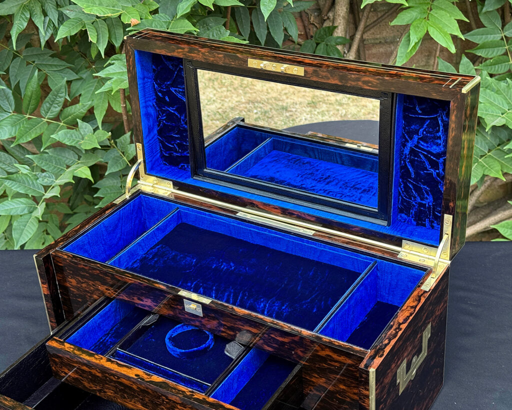 Closer interior view of an antique jewellery box in coromandel, by William Lund, with both concealed drawers opened and mirror on display.