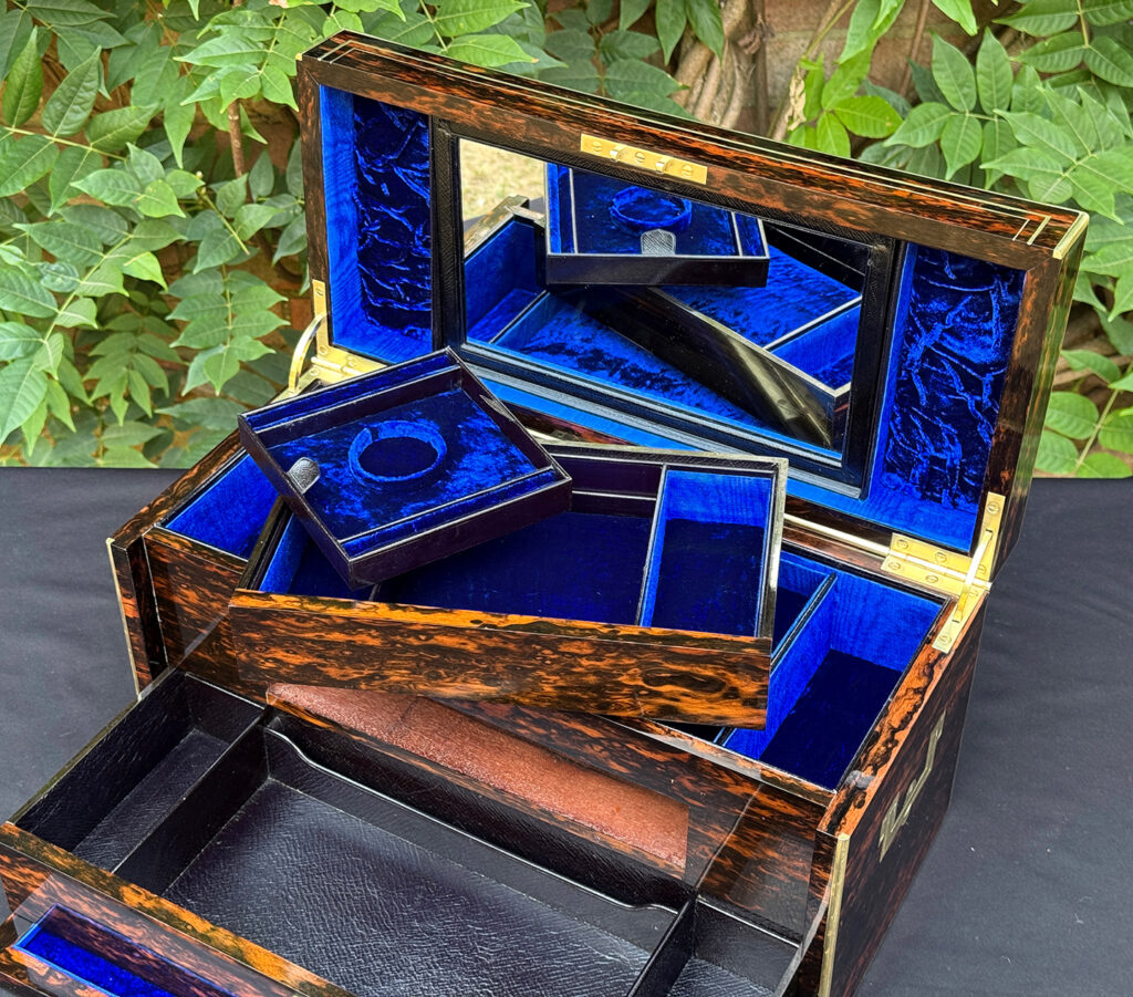 Overhead interior view of an antique jewellery box in coromandel, by William Lund, with top drawer and tray removed.