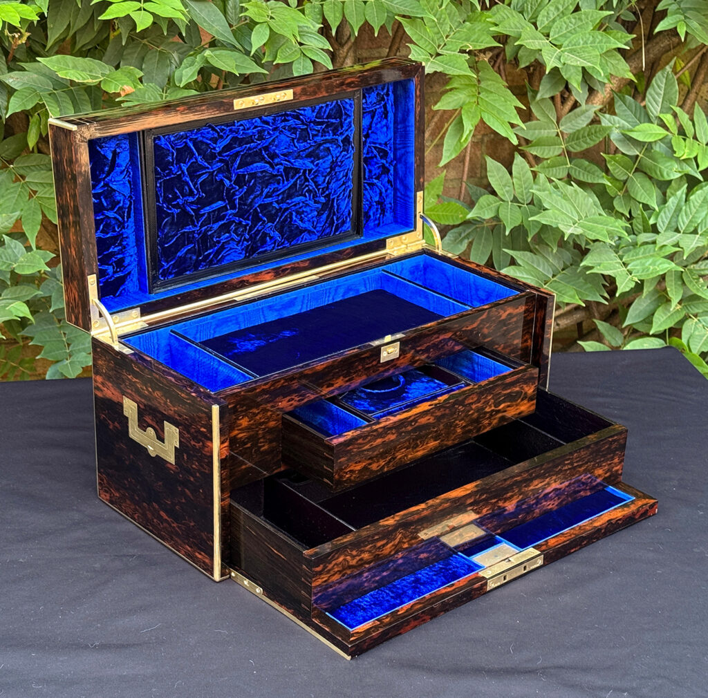 Front left interior view of an antique jewellery box in coromandel, by William Lund, with both concealed drawers opened.