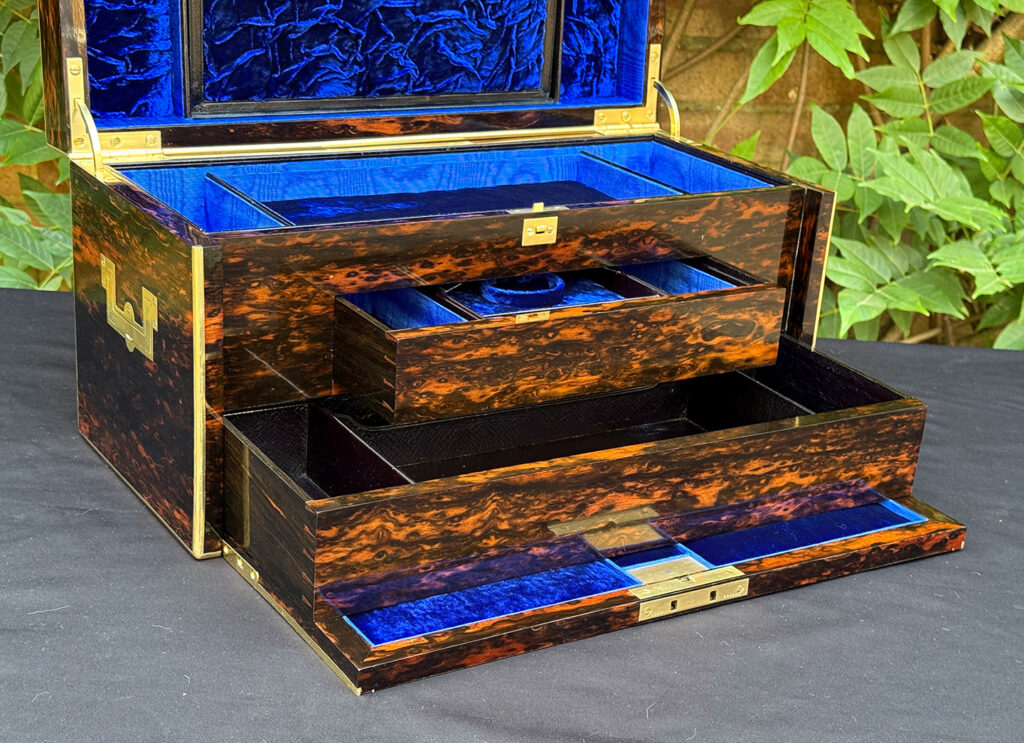 Closer interior view of an antique jewellery box in coromandel, by William Lund, with both concealed drawers opened.